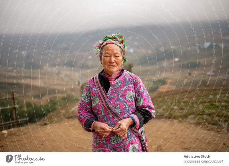 Middle aged ethnic woman standing in field confident farmer rural fence path countryside agriculture nature female mature village plantation house mountain