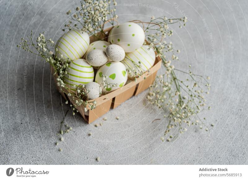 Decorative Easter eggs with spring flowers in basket easter painted stripe dot decoration festive holiday green white baby's breath gypsophila delicate charming