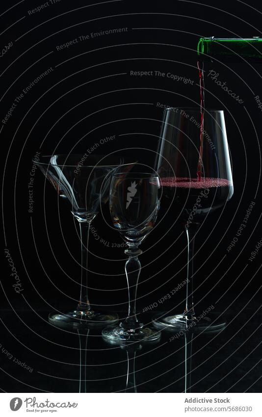 Red wine flowing into glass with stemware silhouette pouring red dark backdrop elegant empty bottle drink alcohol beverage liquid vino reflection black