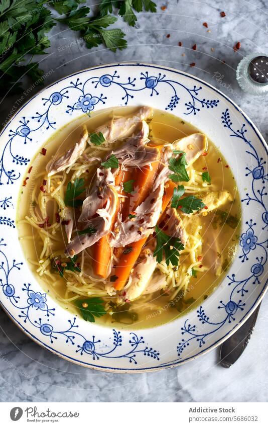 Homemade Chicken Noodle Soup in Decorative Bowl chicken soup noodle carrot parsley comfort food homemade bowl decorative warm dish meal healthy broth cooked