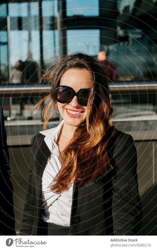 Urban elegance: stylish woman soaking up Madrid's sun smile sunglasses madrid spain urban city style fashion outdoor modern businesswoman casual street