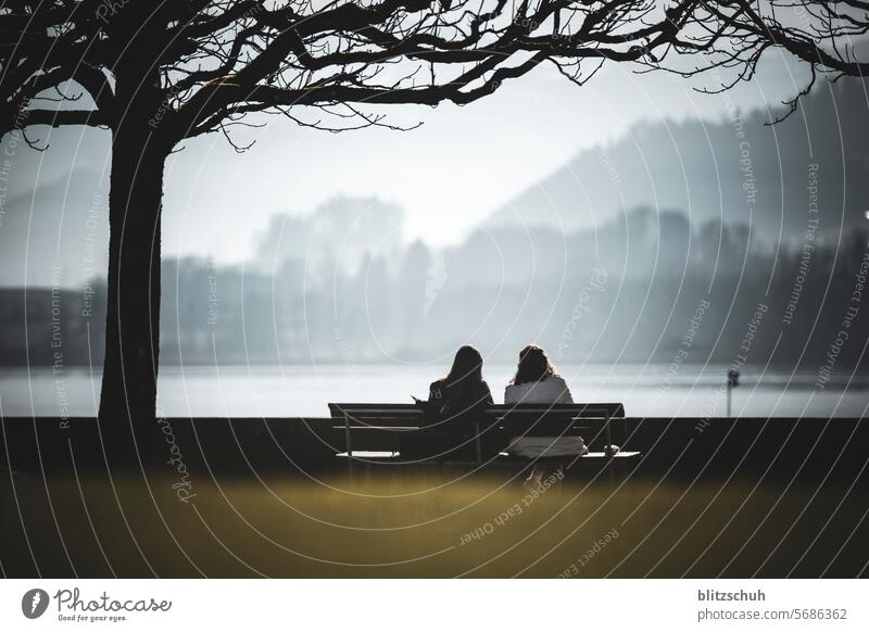 Two women on a park bench enjoying a mild winter's day in February Mild Winter Climate Climate protection Climate change Deep layers Nature Landscape cham Train