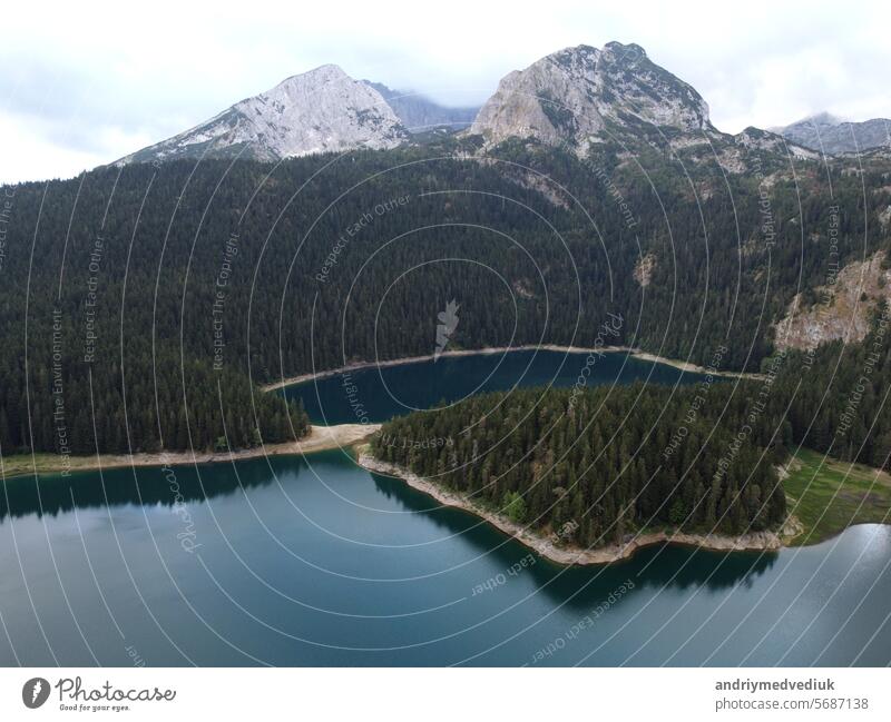 Amazing aerial drone view of Crno Jezero or Black lake, pine forest and cliffs in Durmitor national park, Zabljak, Montenegro. Travel, environment, beauty in nature, relaxing. UNESCO World Heritage