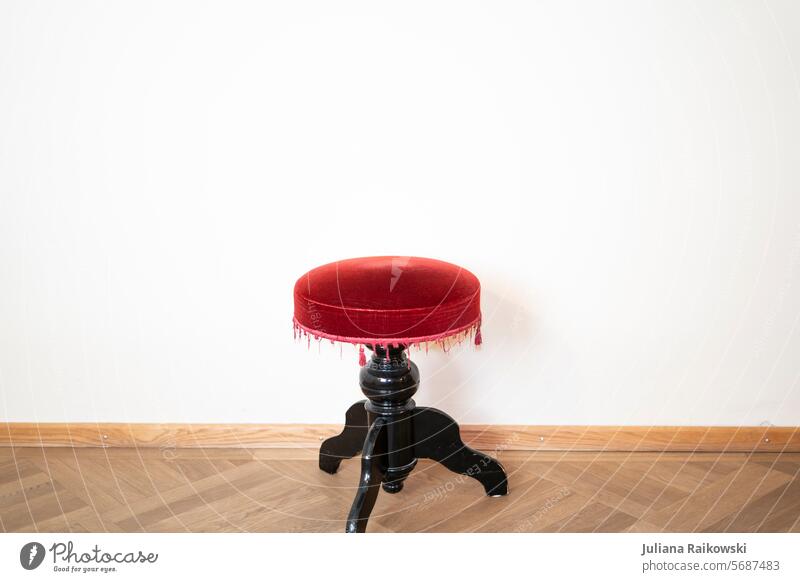 Stool in front of a white wall Wall (building) Chair Seating Furniture Deserted Sit Places Empty Free Theatre Red Colour photo Ground Seating capacity Wait
