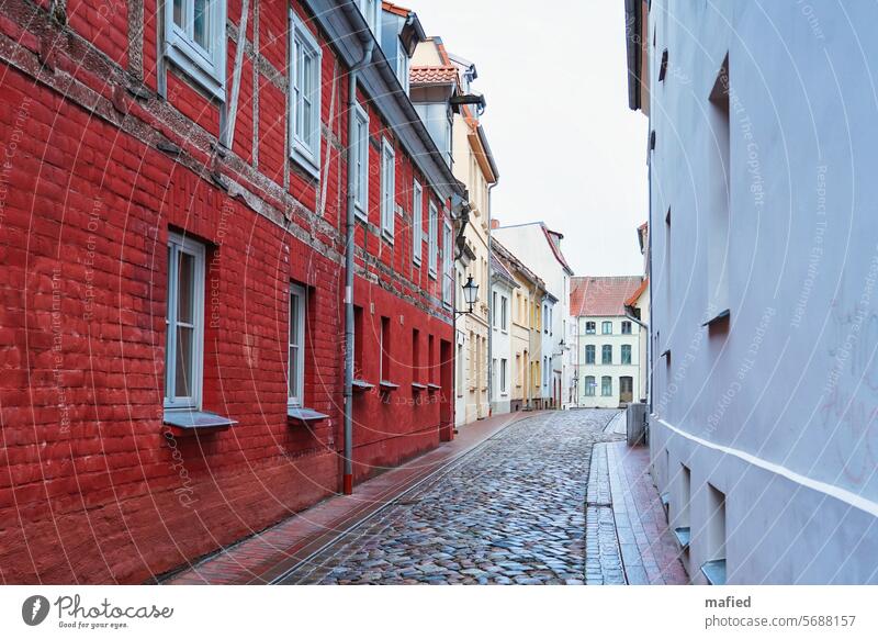 Old Town Lane in Wismar Hanseatic City Medieval times half-timbered Cobblestones row of houses Alley refurbishment Preservation of historic sites Brick Plaster