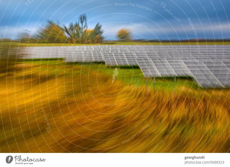 Passing a landscape with forest in early fall with photovoltaic system, blurred and zoomed. drive past hazy Movement motion blur Meadow Forest trees Nature