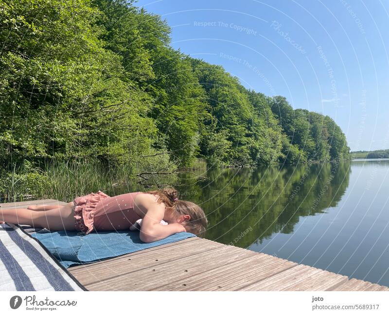 Girl lying in a swimsuit on a jetty by the lake Summer Summer vacation Summery Swimsuit Child Infancy Lake Lakeside bathe Beach vacation Water bathing fun