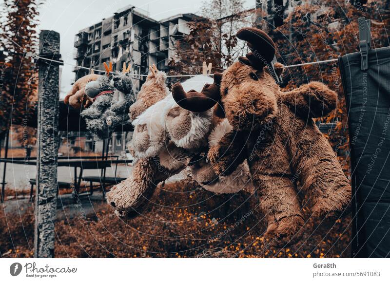 soft toys are dried after washing against the background of a burnt-out building in Mariupol Donetsk Kherson Kyiv Lugansk Russia Ukraine Zaporozhye abandon