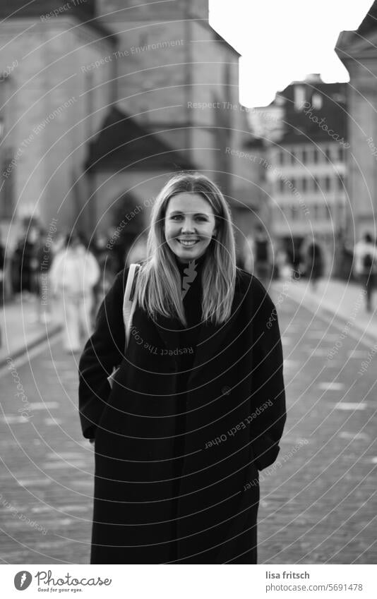 YOUNG WOMAN - BLACK AND WHITE - CITY LIFE Woman long hairs Coat Town City life Chic pretty Lifestyle Attractive Exterior shot Easygoing Fashion portrait Adults
