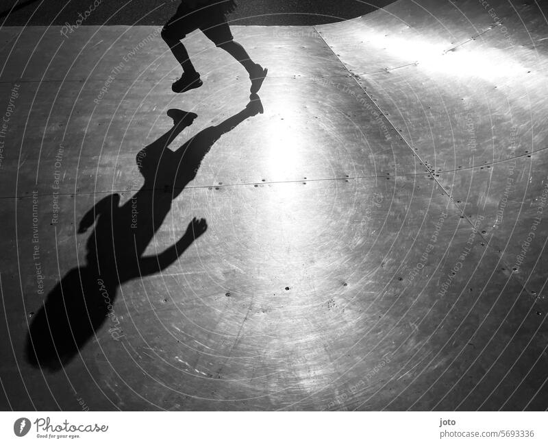 Silhouette of a child running and playing on a skating rink Silhouette people Silhouette photography Shadow Shadow play shadow cast Shadow image children