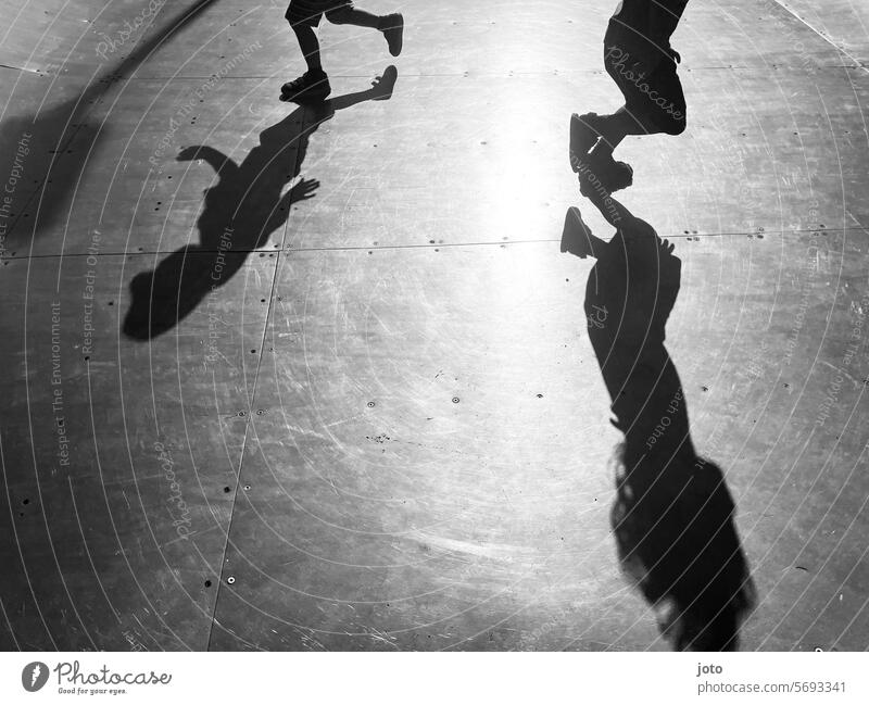 Silhouettes of children playfully run back and forth on a skating rink Silhouette people Silhouette photography Shadow Shadow play shadow cast Shadow image