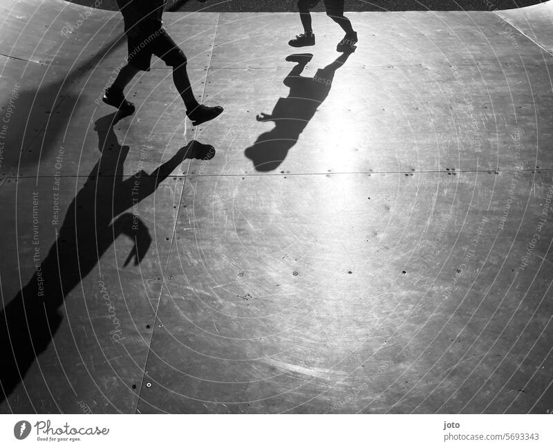 Silhouettes of children playfully run back and forth on a skating rink Silhouette people Silhouette photography Shadow Shadow play shadow cast Shadow image