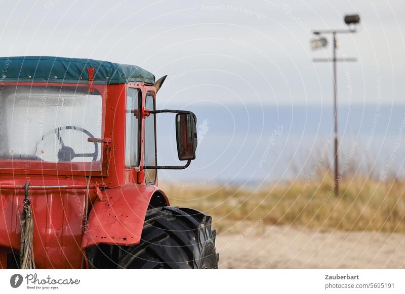 Red tractor with a view on the beach by the Baltic Sea Tractor Tug outlook Beach atmospheric peasant Farmer protest End Exit route Futile nostalgically Old