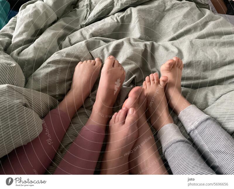 3 pairs of feet of a family together on one bed Feet Quantity children Children's Feet Family Family & Relations Domestic happiness in the morning morning mood