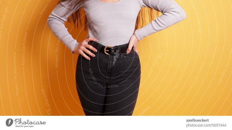 curvy young woman with womanly figure or curves wearing tight black jeans cameltoe fashion shape shapely hips body part women health female person adult