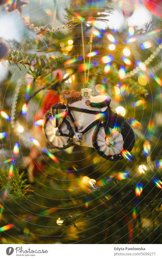 Bike Ornament Hanging on a Christmas Tree multi colored bike bicycle Decorating Close-up Christmas Ornament Decoration Fir Tree Holiday - Event Lifestyles