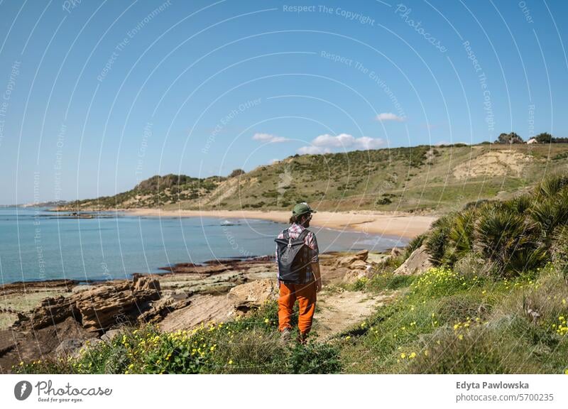 Man hiking along coastline in Sicily, Italy walking man outdoors happiness beach people active one person travel Looking At View adventure exploration scenics