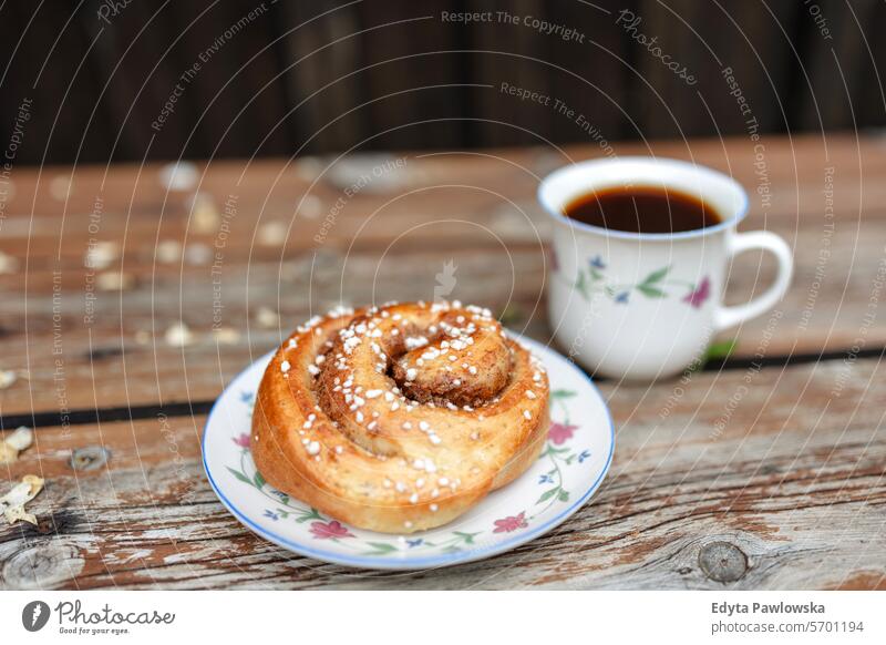 Cup of coffee and plate with cinnamon roll bakery breakfast brown bun cinnamon bun close-up cup of coffee delicious dessert drink food sweet fika fresh homemade