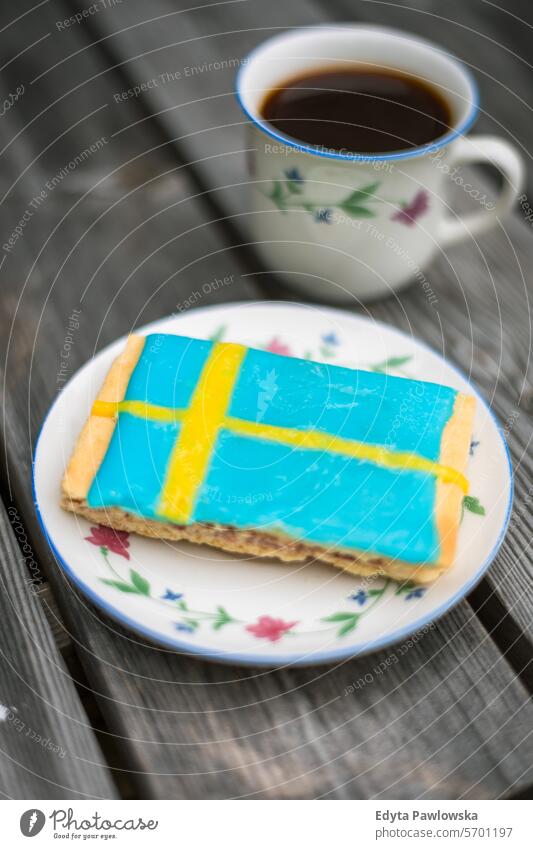 Cup of coffee and cake colored with Swedish flag Swedish culture bakery breakfast close-up cup of coffee delicious dessert drink food sweet fika fresh homemade