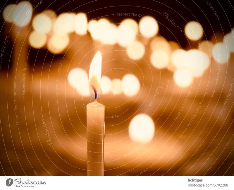 Single candle in front of blurred points of light shoulder stand clearer candlelight Loneliness Flame