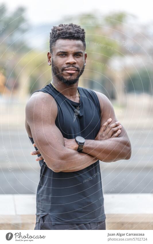 Confident black sportsman standing on street portrait break athlete determine workout town healthy arms crossed fitness confident male young african american