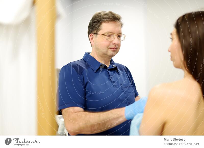 Doctor mammologist examines woman breasts. Correcting the shape of the breast - lift, reduction, reconstruction, augmentation. Problems of lactation. Breast cancer.