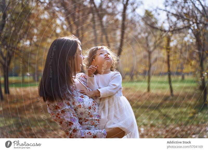 Ethnic mother and child enjoying autumn park daughter ethnic nature california usa bonding pointing love family female sunny outdoors leisure maternal parental