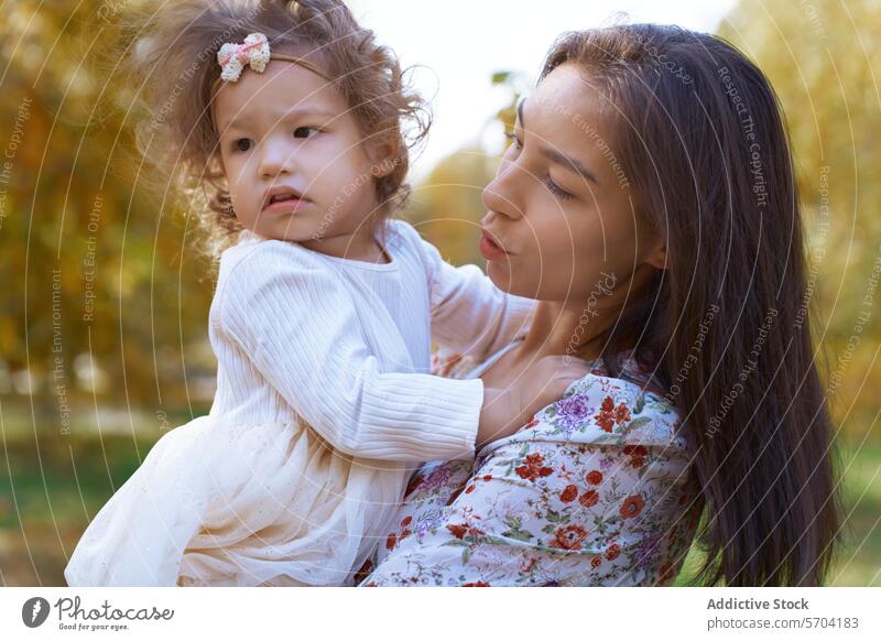 Ethnic mother and daughter bonding in California park nature california usa ethnic family love affection tenderness sleepy child woman embrace hug closeness