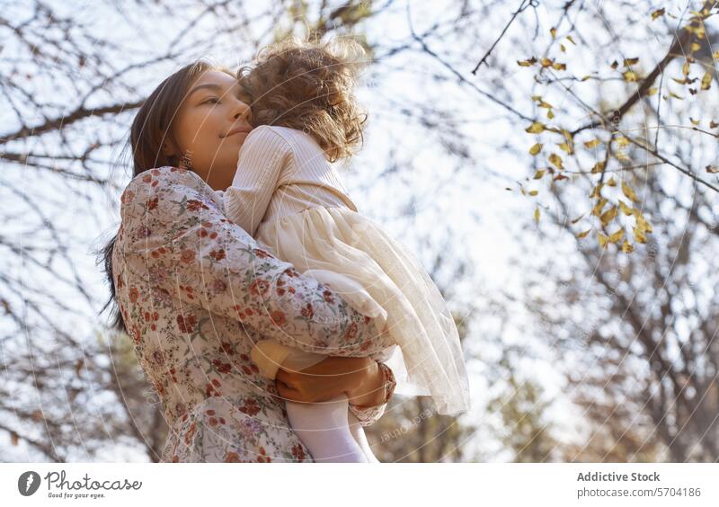 Ethnic mother and child embracing in sunny park daughter ethnic embrace nature california usa bonding love family outdoors tranquility peaceful affection