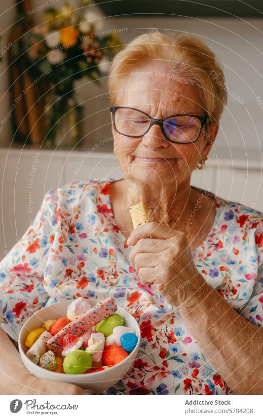 Elderly Woman Enjoying a Bowl of Colorful Sweets elderly woman sweet candy biscuit bowl vibrant colorful pleasure age senior happiness joyful dessert snack