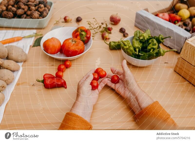 Preparing vegetables on a wooden kitchen table hands cherry tomatoes wooden table meal prep healthy assorted fresh cooking food preparation ingredient