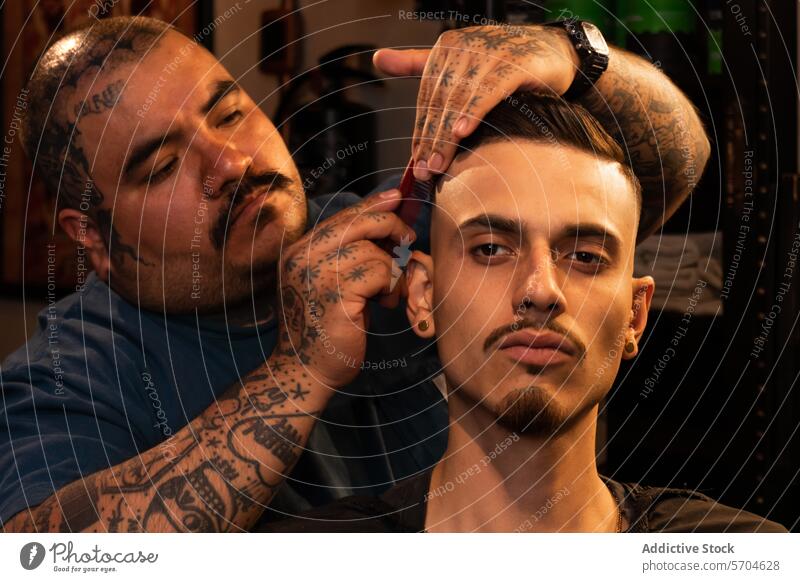 Barber trimming hair of client in barbershop grooming trimmer man cut process guy haircut men male serious work hairstyle hipster barber shop instrument care