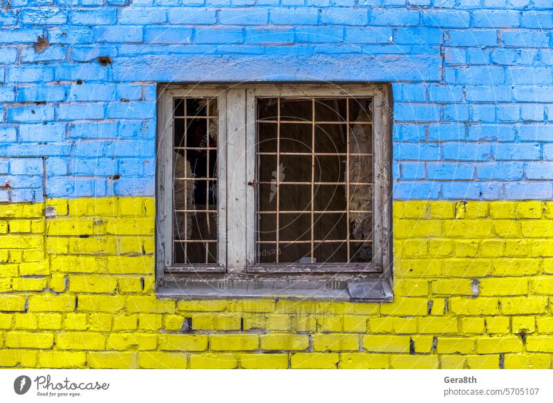 pattern explosion damaged blue yellow house wall with window in Ukraine Donetsk Kherson Kyiv Lugansk Mariupol Russia Zaporozhye abandon abandoned attack