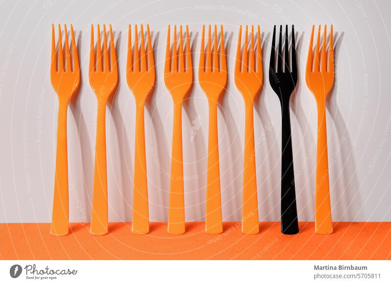 Seven orange and one black plastic fork on an orange and white background Art Fork Orange Meal Eating Spoon White Simple Cutlery utensils Blue Café Knives Black