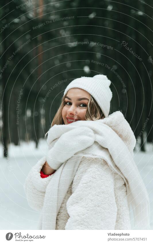 Blonde woman in winter forest or park enjoying nature alone happy mood cold fur coat mittens pullover red white hot beverage take away snow female eco paper tea
