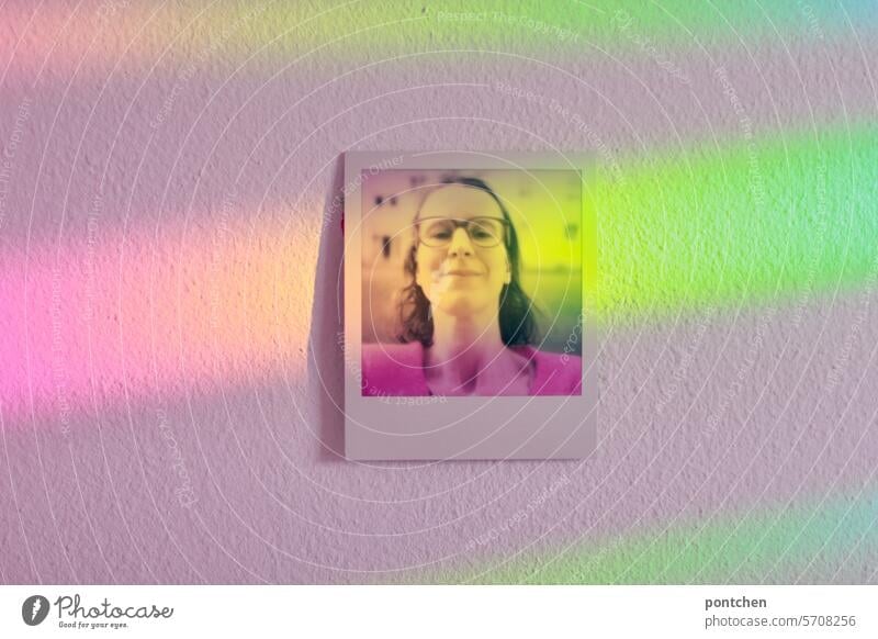 polaroid of a woman hangs on a wall and is flooded with rainbow-colored light Polaroid Selfie Woman Eyeglasses Wall (building) Rainbow Light Ornate Hang