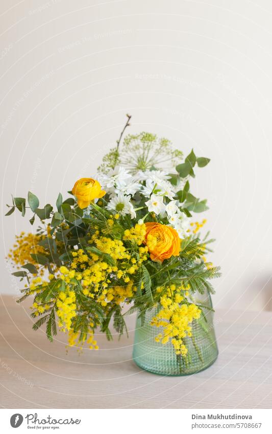 beautiful minimal bouquet with yellow mimosa spring flowers. Fresh elegant home decor. Florist work. salon vase florist floristry eucalyptus leaves leaf green
