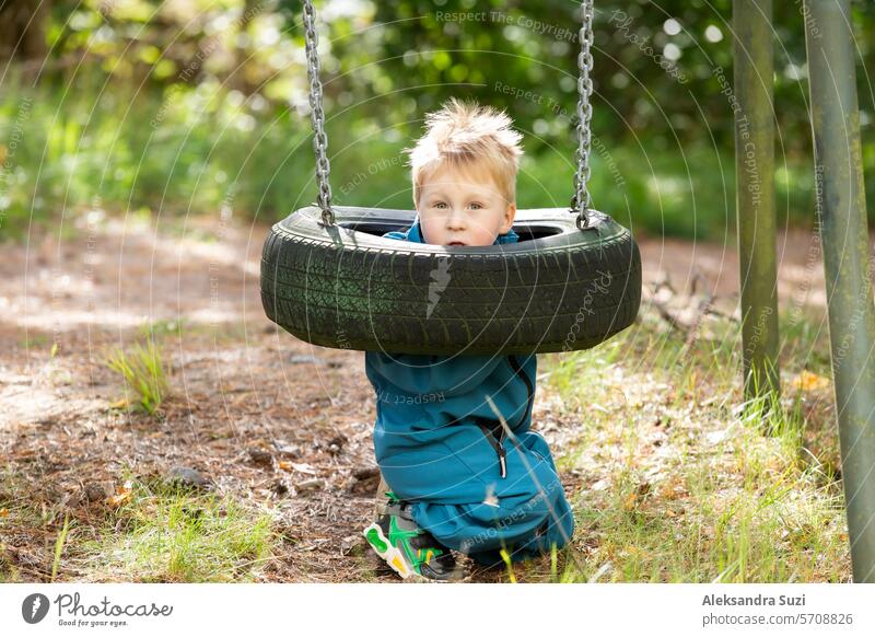 A little boy is playing on the playground. active activity adult baby beautiful care caucasian child childhood childrens day cute family fun garden happiness