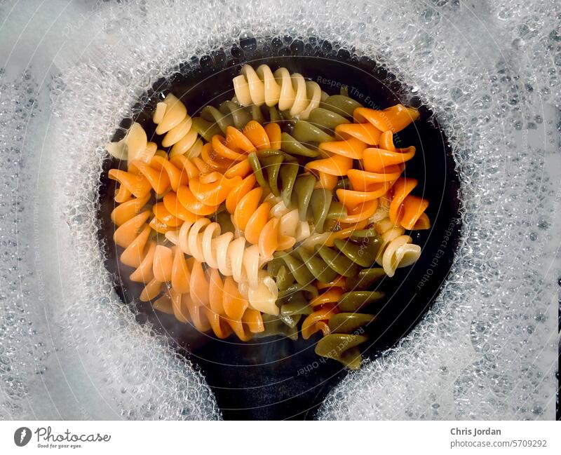 Tricolor Rotini Pasta Water boiling bubbles Close-up Cooking Spiral Healthy