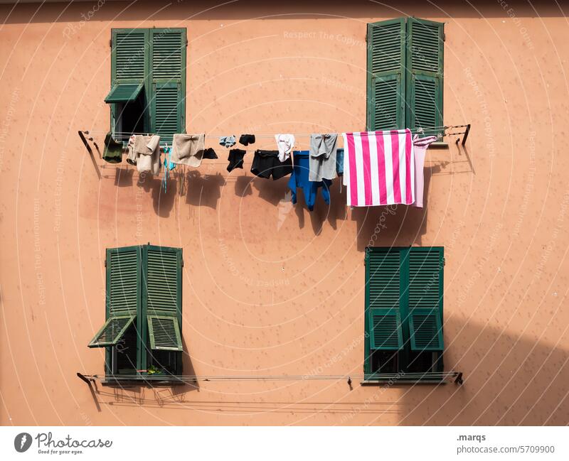 Drying laundry Laundry Hang Facade Mediterranean Window warm Wall (building) Living or residing Italy Clean Apartment house