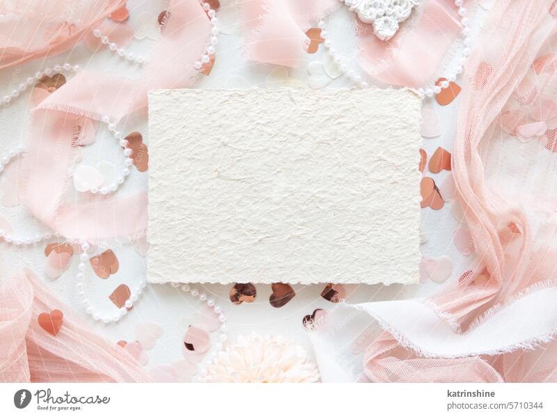 Card near pink decorations, hearts and silk ribbons on white table top view, mockup WEDDING card romantic valentines paper vertical pearls spring mothers day
