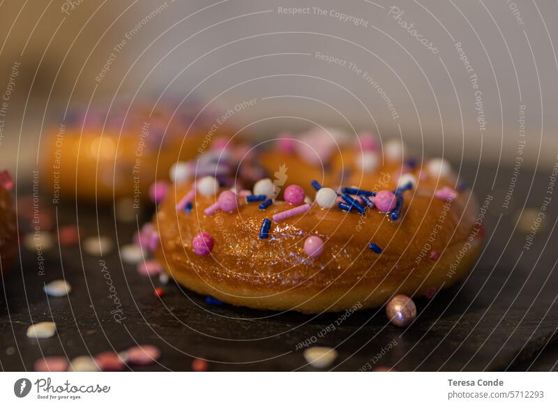 closeup of donuts with colorful sprinkles on blackboard Multicoloured Dessert Sweet Sugar Donut glaze colourful To enjoy Love pearl Food Round Delicious Circle