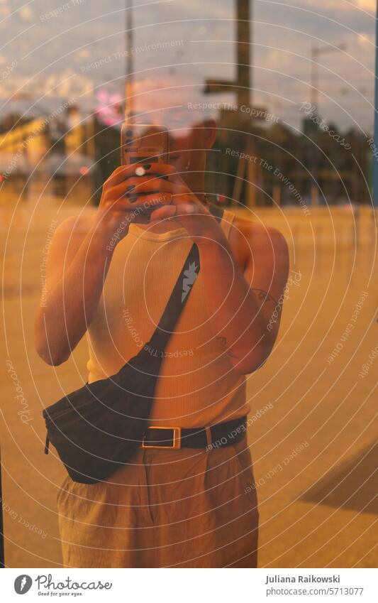 young man takes a photo with his cell phone Summer Easygoing street style Hip & trendy Day Colour photo Modern Street naturally 1 portrait urban Slice Orange