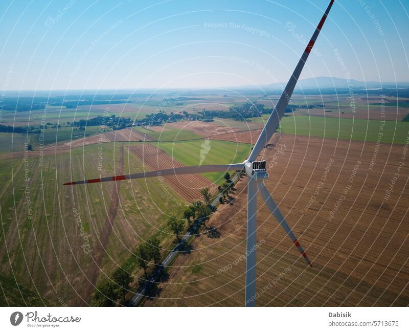 Aerial view of wind turbine in countryside area energy sustainable renewable generator windmill clean landscape green eco friendly field blades alternative farm