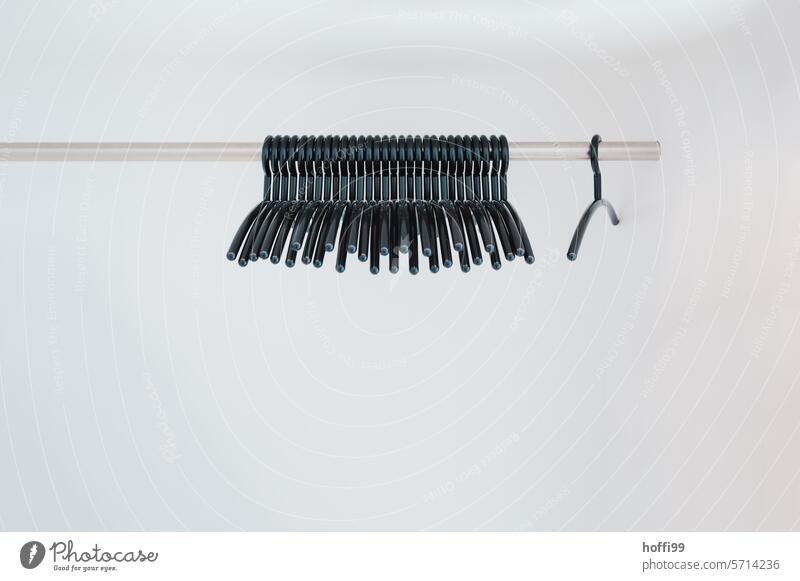 minimalist view of clothes hangers on a bar against a light background Hanger Coatrobe Minimalistic pole Hallstand Empty Vacancy Clothing Fashion garments