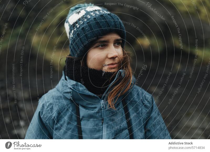 Contemplative woman in the Icelandic outdoors iceland trip female wilderness thoughtful beanie jacket cold nature solitude travel exploration icelandic