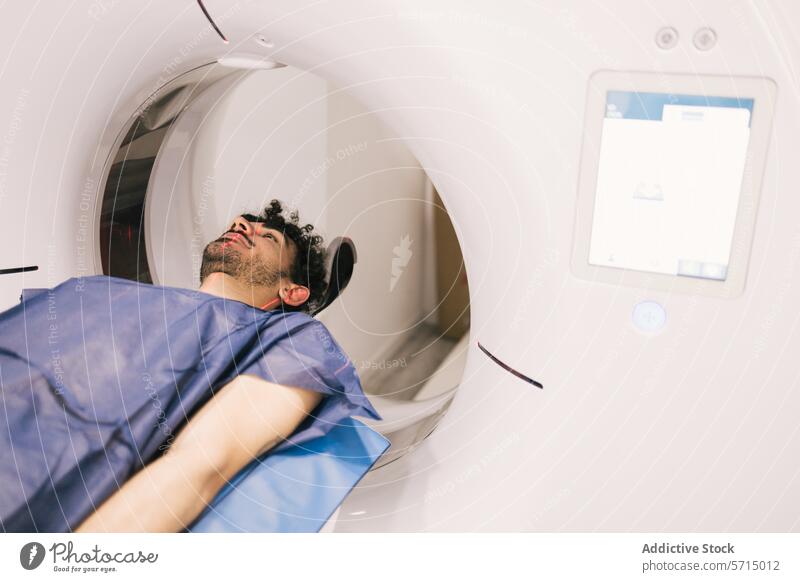 Man undergoing a CT scan in a medical facility ct scan patient diagnostic radiological procedure healthcare center male lying still scanner hospital imaging