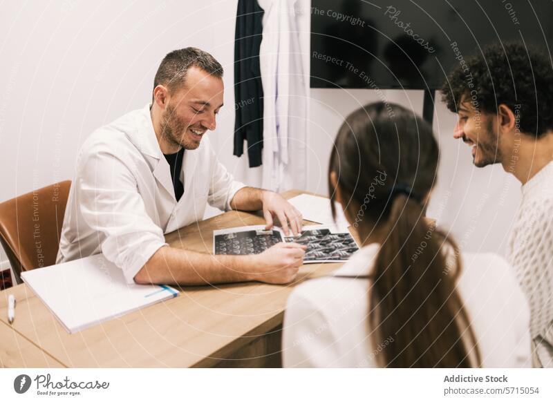 Smiling doctor discusses X-rays with patients at clinic x-ray medical office healthcare health care consultation communication couple male female smiling