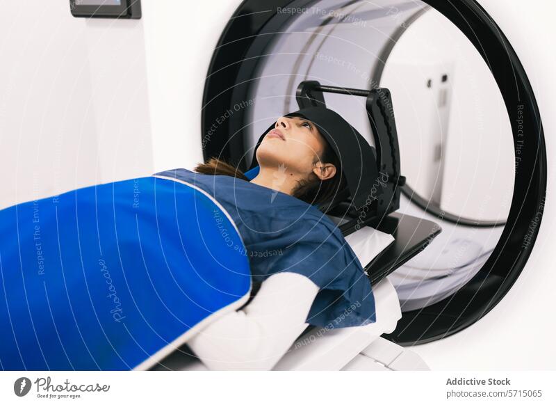 Patient undergoing a scan in a modern MRI machine patient mri scanner medical imaging healthcare hospital technology diagnosis radiology equipment examination