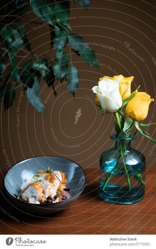 Grilled chicken with beans on a plate by yellow roses grill herb garnish elegant presentation glass vase wood table leaf green flower meal dish cuisine